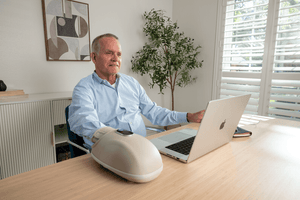 A Old Man Use Hand Massager In The Office