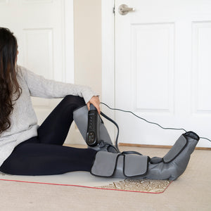Woman Uses Leg Calf Massager On The Floor