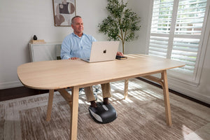 old man use foot massager in the office